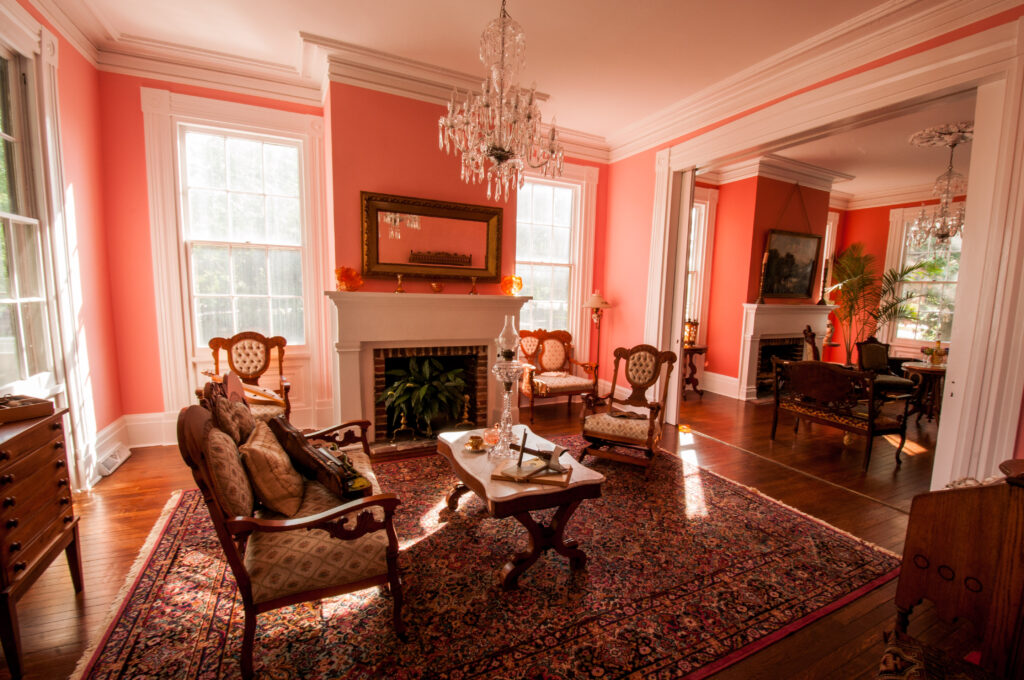 The front parlour with its chandelier, armchairs and patterned rug