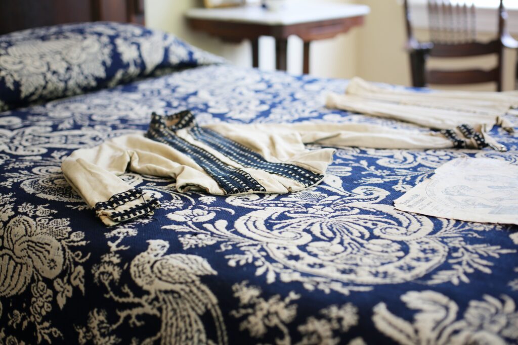 A manor house bedroom with a blue and white bedspread
